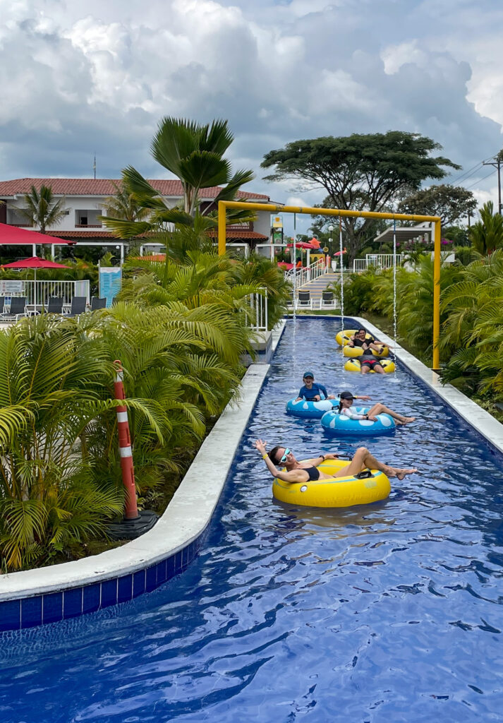 Enjoying the lazy river at Las Camelias Resort, a fun family resort for kids to put on your Colombia 3 week itinerary. 