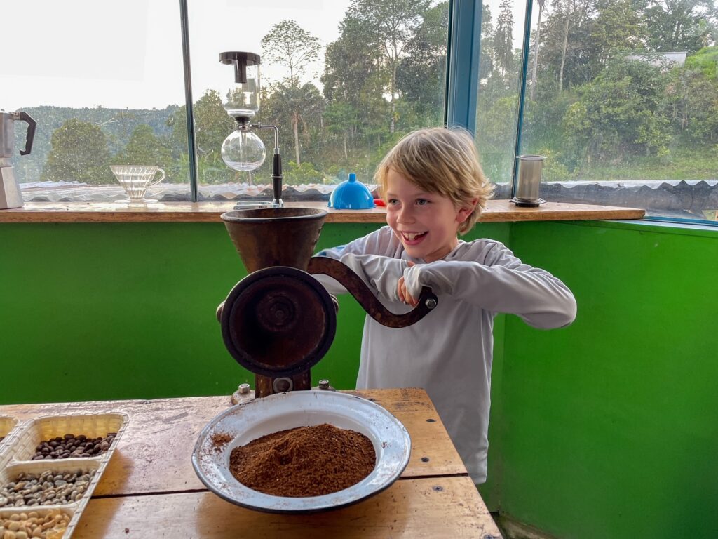 Jagger is grinding the coffee beans during a tour of a coffee farm outside of Medellin.