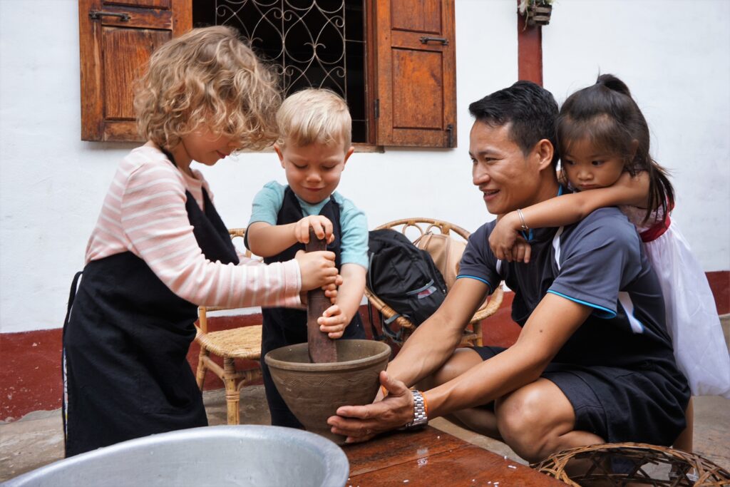 Taking a cooking class in Laos at a local family's home is a cultural immersion form of schooling while traveling.