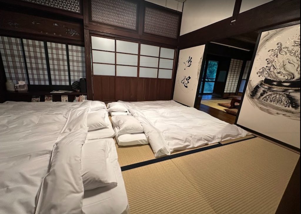 bedroom at Magokoro Inn with traditional tatami beds, a unique family stay in Japan
