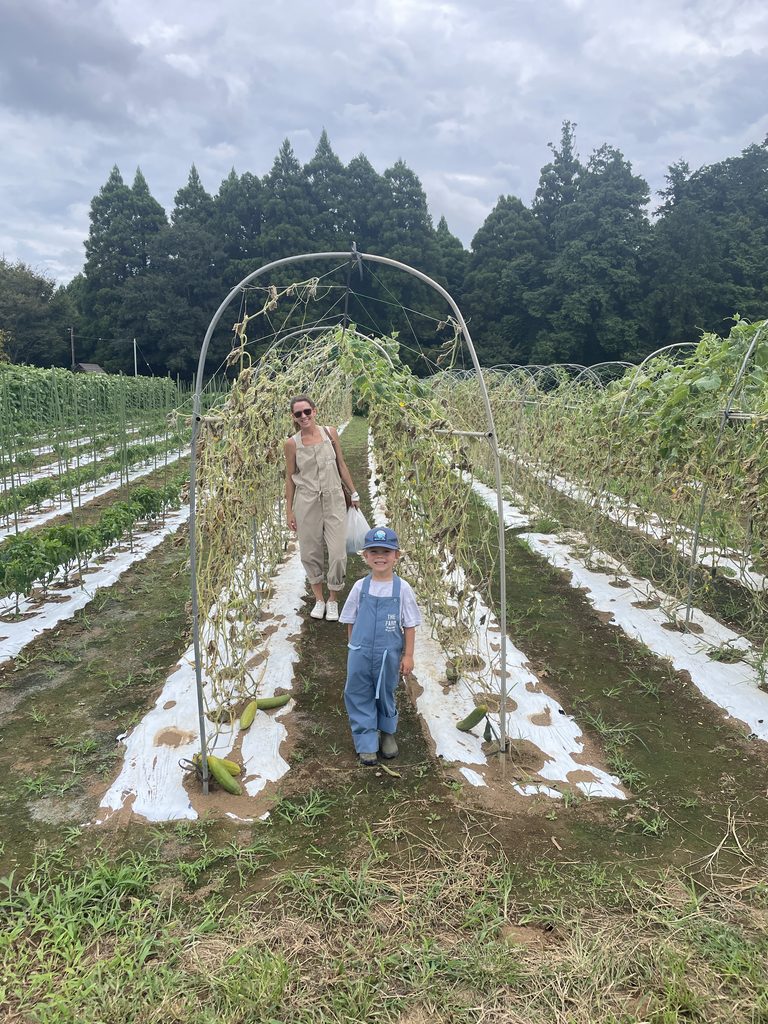 mother and son harvesting veggies at The Farm resort in Japan, a family friendly unique resort.