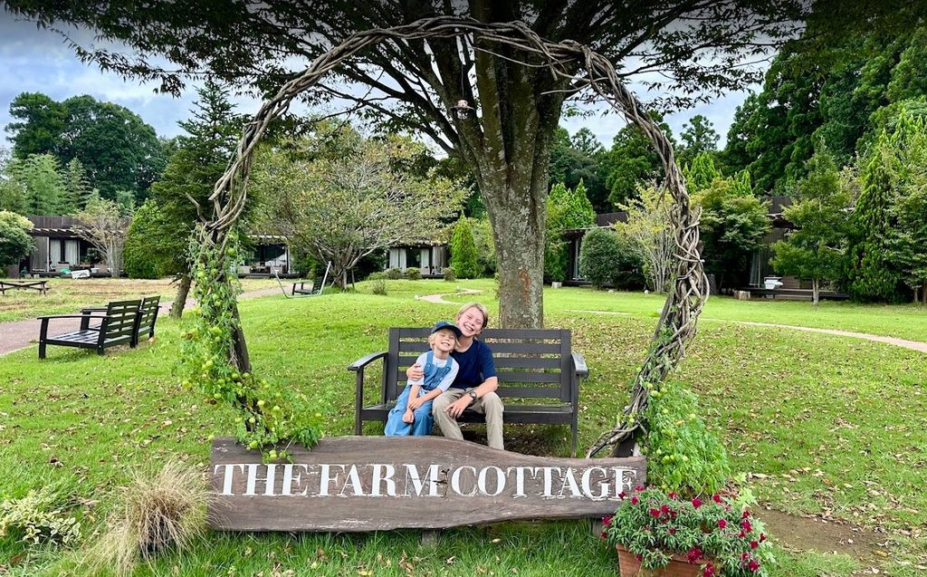 A photo of two brothers sitting on a chair at The Farm Resort in Katori Japan, a unique place to stay for families in Japan.